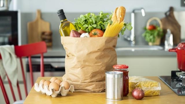 A kraft paper carry sack contains grocery items